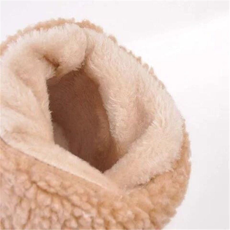 Close-up of a plush, beige pet bed with a soft texture on a white background.