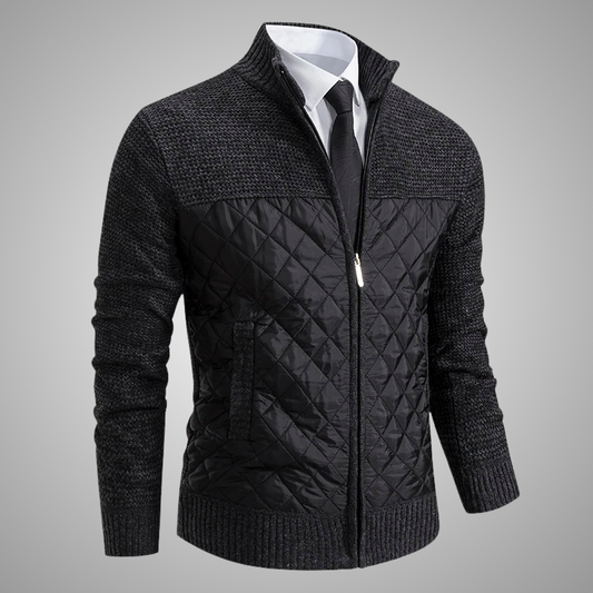 Black quilted jacket with a white shirt and tie on a gray background