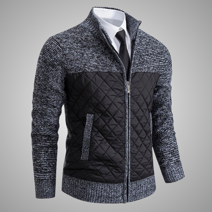 Gray and black quilted jacket on a gray background