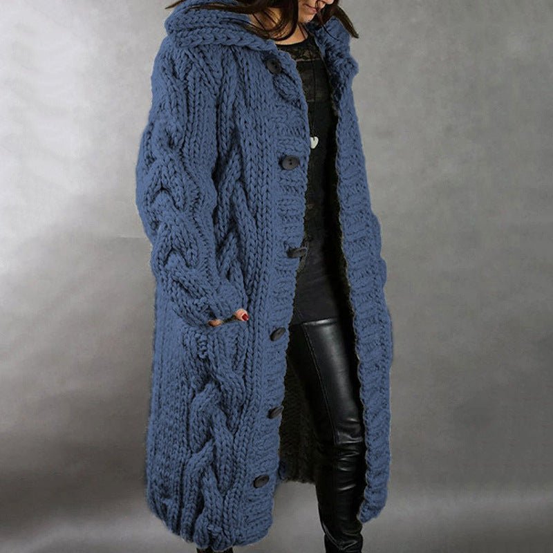 Blue knitted coat worn by a person on a gray background
