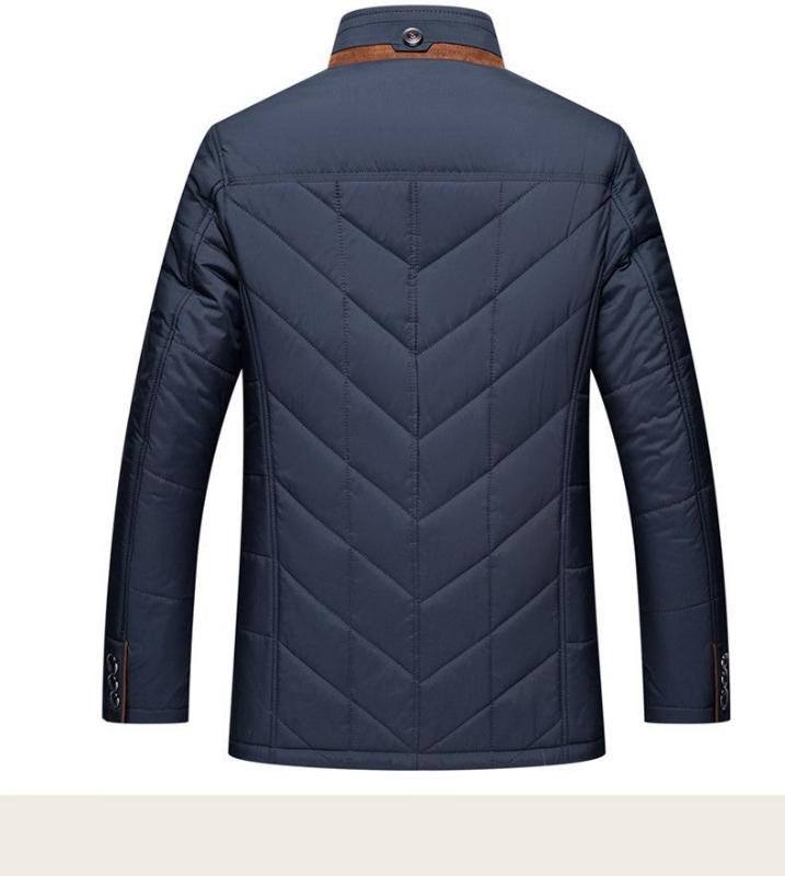 Navy blue quilted jacket on a white background