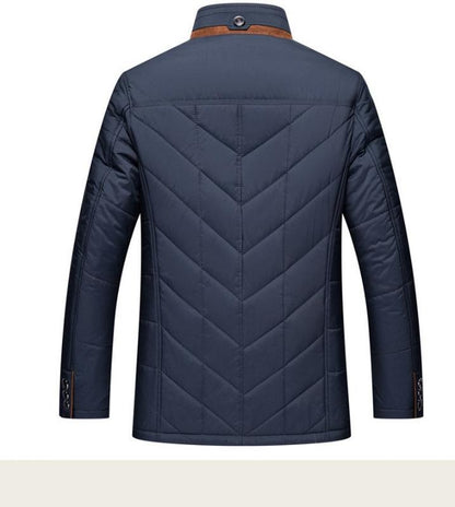Navy blue quilted jacket on a white background