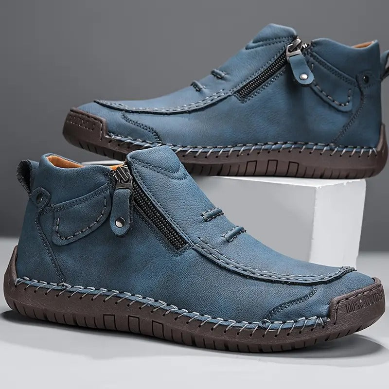 Blue leather shoes with zippers on a gray background