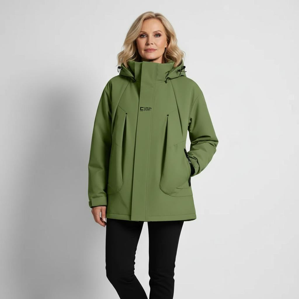 Woman wearing a green jacket on a gray background