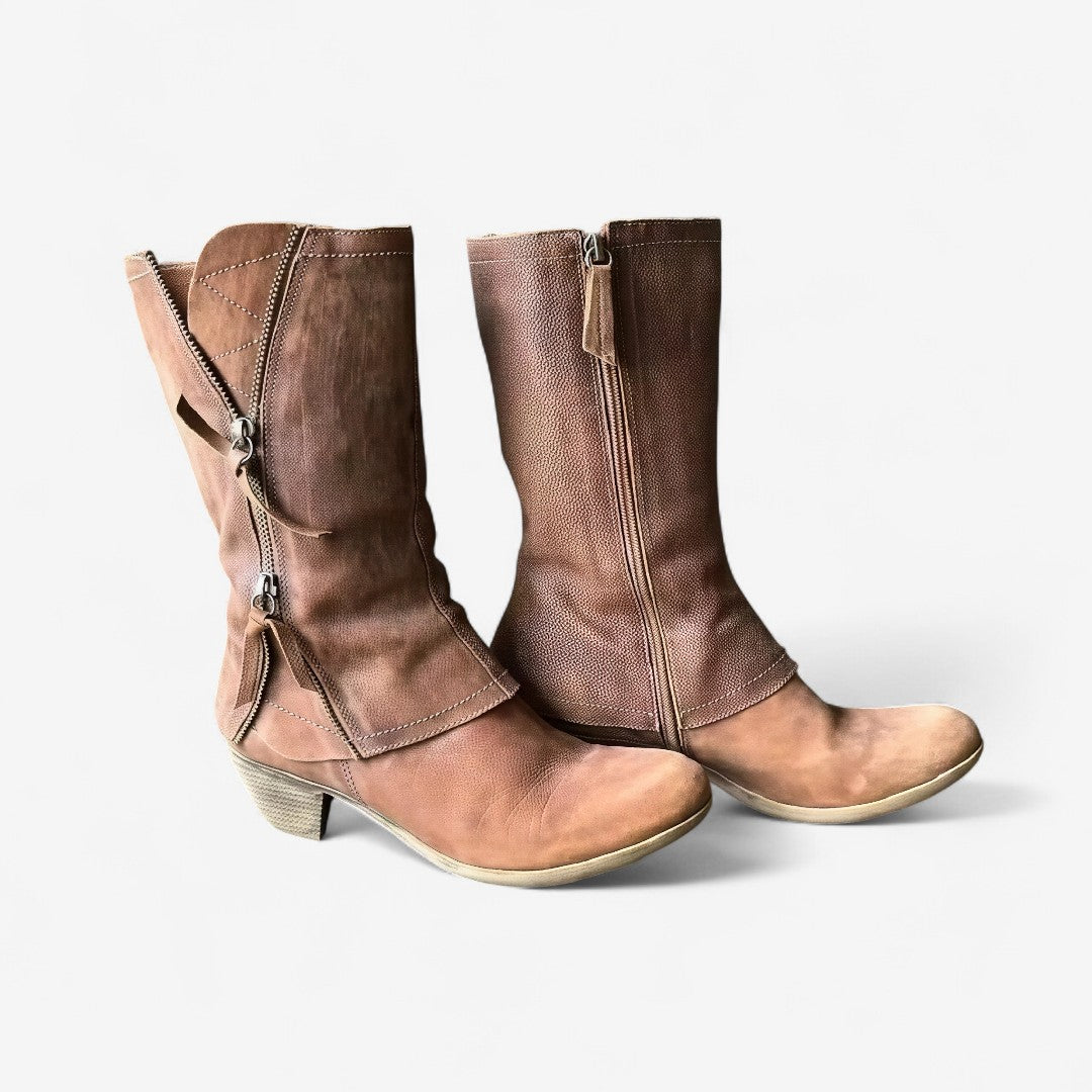 Pair of brown leather boots with zippers on a white background