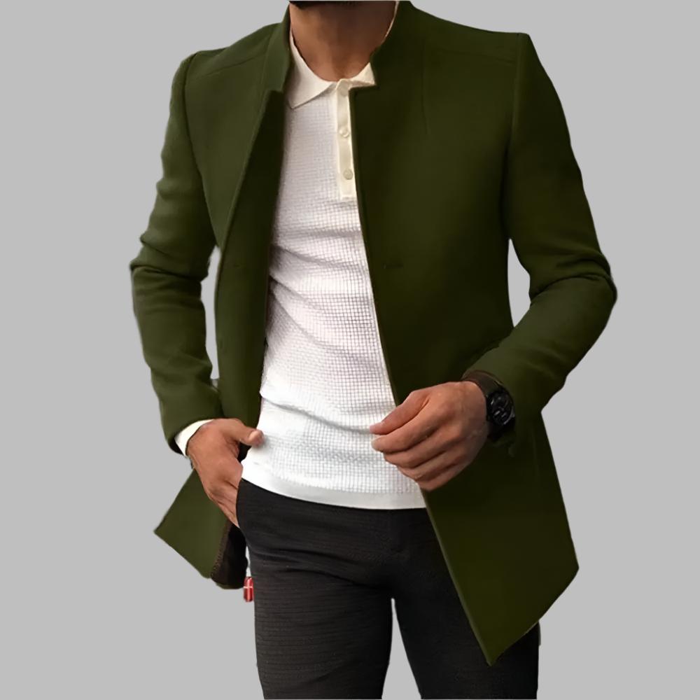 Green jacket over a white shirt and black pants on a gray background