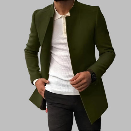 Green jacket over a white shirt and black pants on a gray background