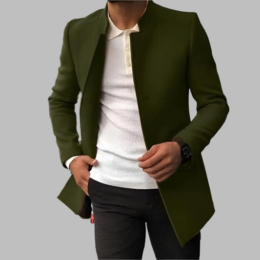 Green jacket over a white shirt and black pants on a gray background
