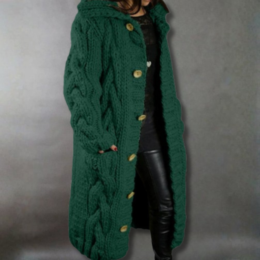 Green knitted coat with button details on a plain background