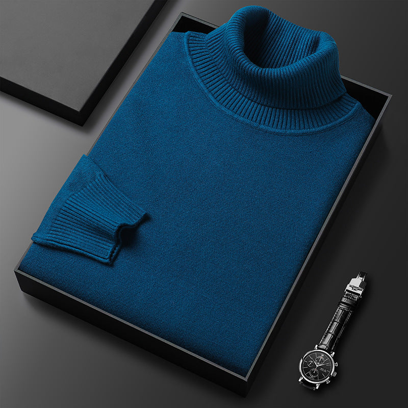 Folded turquoise blue turtleneck sweater displayed with a watch.