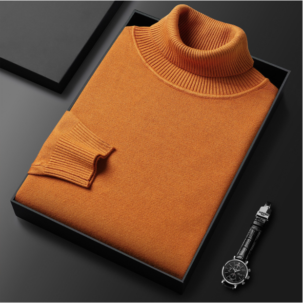 Folded orange turtleneck sweater displayed with a watch.