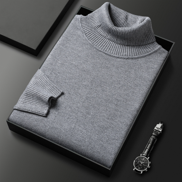 Folded light gray turtleneck sweater displayed with a watch.