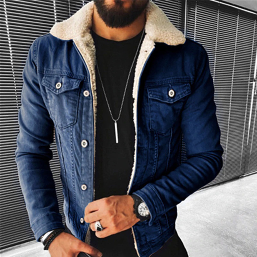 Man wearing a blue denim jacket with white fur lining against a metallic background