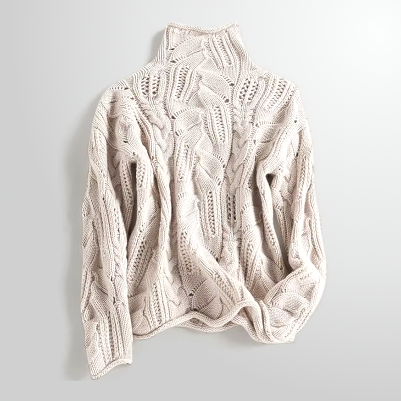 Beige cable knit sweater on a light gray background