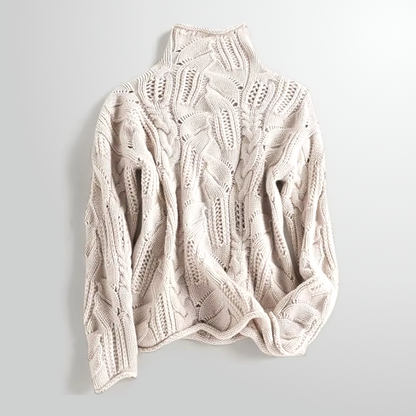Beige cable knit sweater on a light gray background