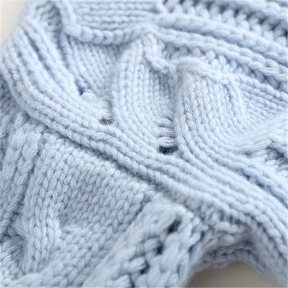 Close-up of light blue knitted yarn with cable pattern