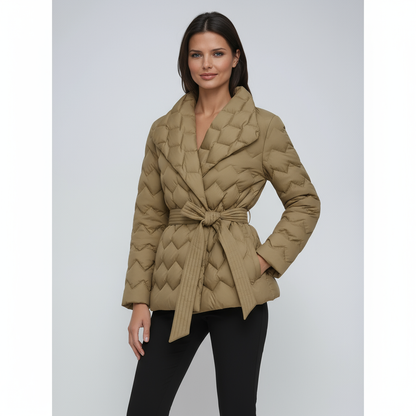 Woman wearing a beige quilted jacket on a light gray background