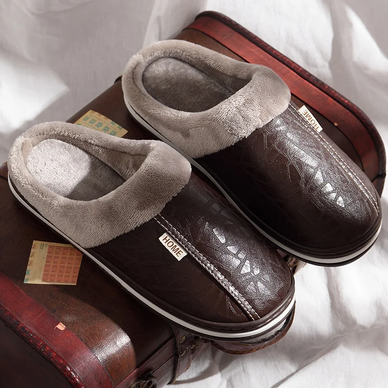 Pair of brown slippers with gray fur lining on a white surface