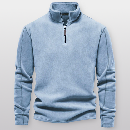 Light blue pullover with a zipper on a light gray background