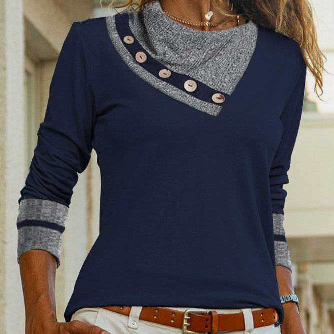 Navy blue long-sleeve top with gray collar and buttons, worn by a person.