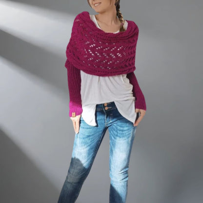 Person wearing a purple knitted shawl over a white shirt and blue jeans on a gray background