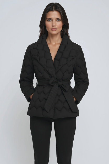 Woman wearing a black textured blazer and pants on a white background