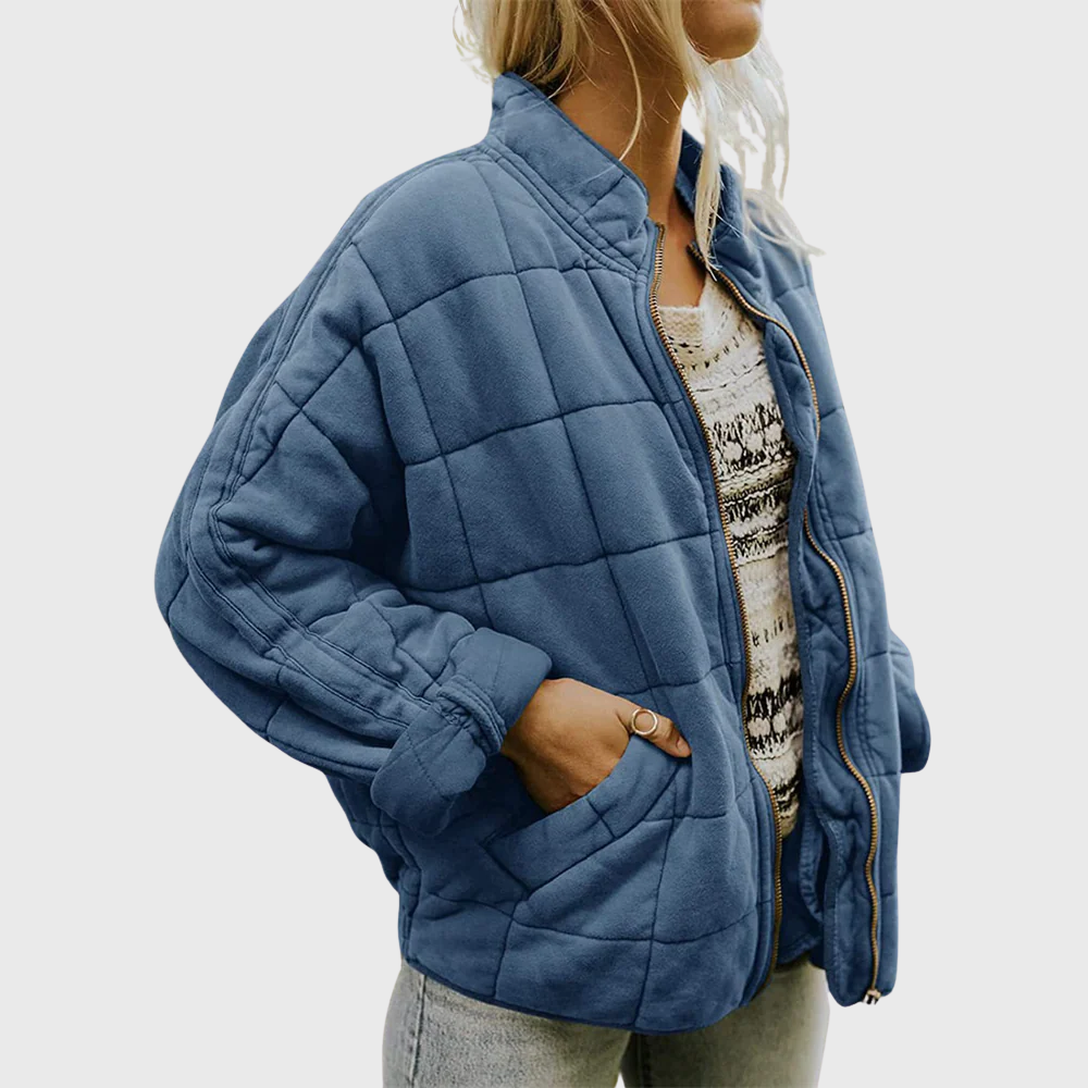 Person wearing a blue quilted jacket on a white background