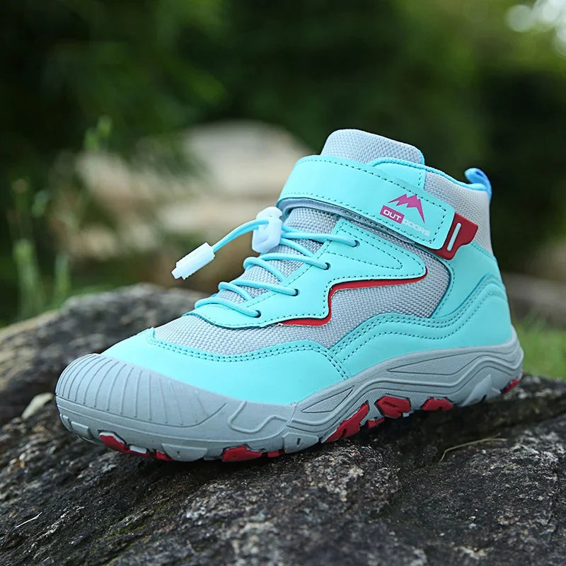 Light blue and gray sneaker with red accents on a rock