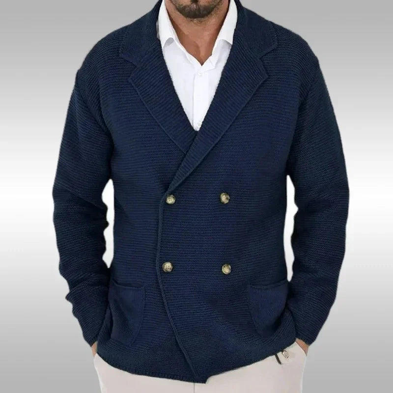 Navy blue double-breasted blazer worn by a person on a gray background