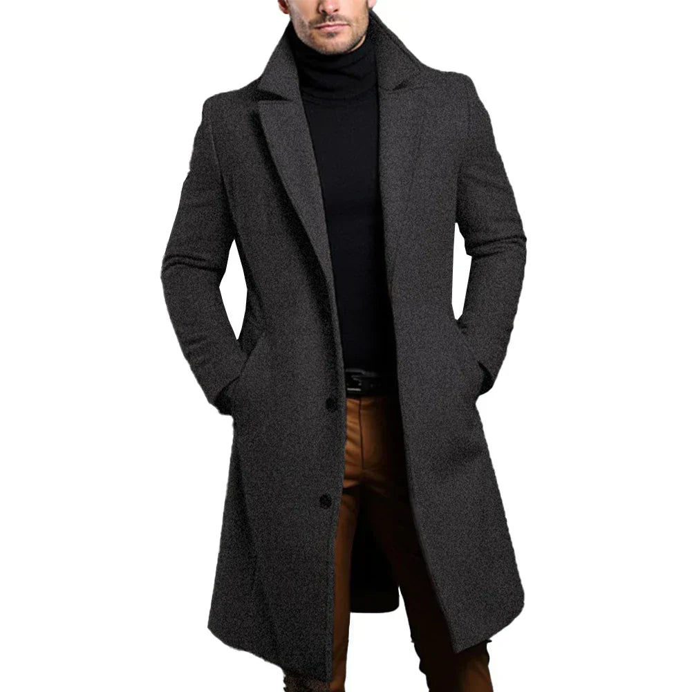 Man wearing a long gray coat on a white background