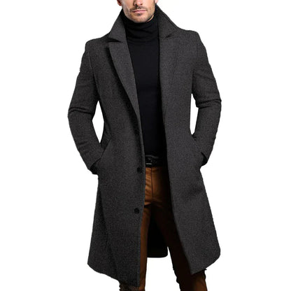 Man wearing a long gray coat on a white background