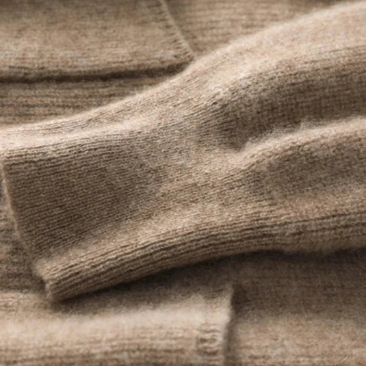 Close-up of beige textured fabric, possibly a rug or textile.