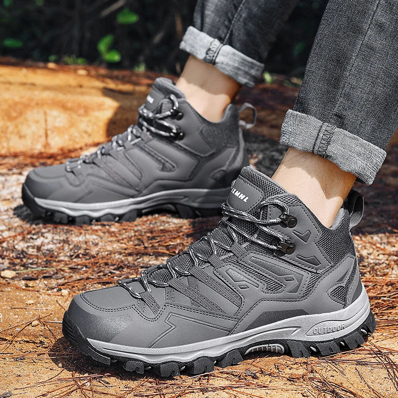 Gray hiking boots worn outdoors on a natural ground surface