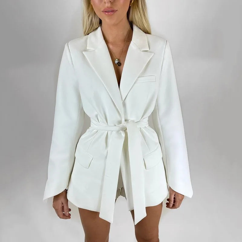 White blazer worn by a person on a plain background