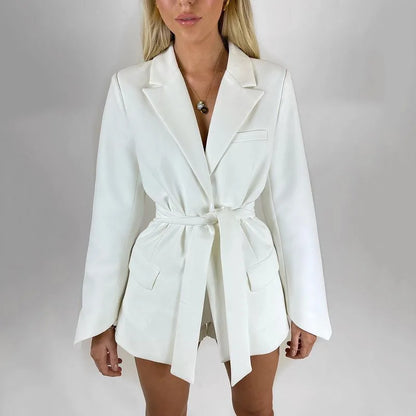 White blazer worn by a person on a plain background