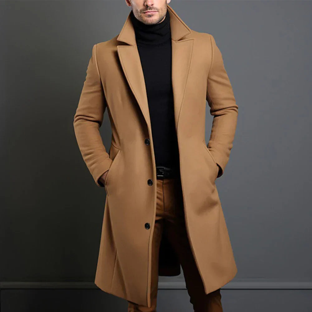 Man wearing a brown coat against a gray background