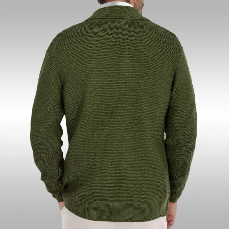 Green sweater worn by a person on a light gray background