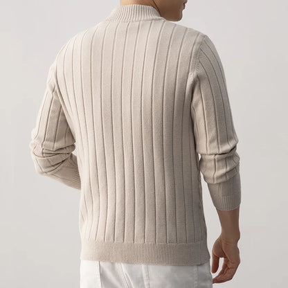 Beige ribbed sweater worn by a person on a plain background