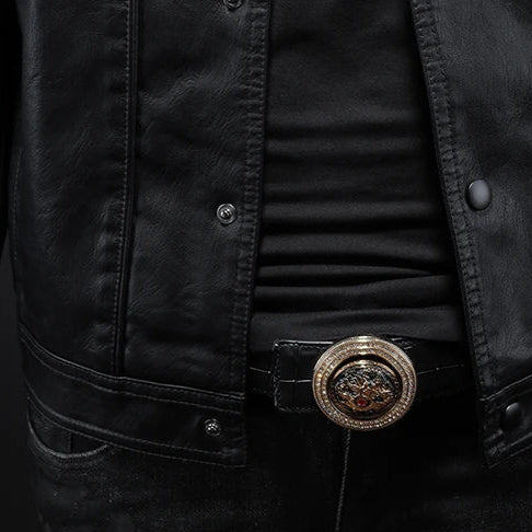 Close-up of a person wearing a black jacket with a decorative belt buckle.