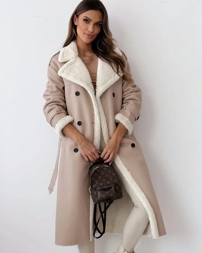 Woman wearing a beige coat with white fur lining, holding a brown backpack against a white background