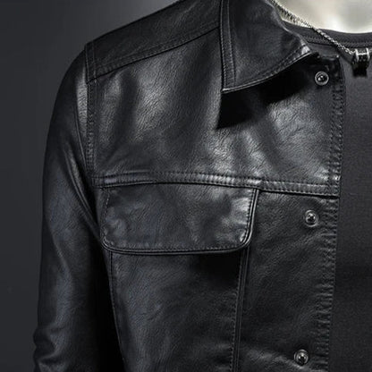 Close-up of a black leather jacket with a dark background