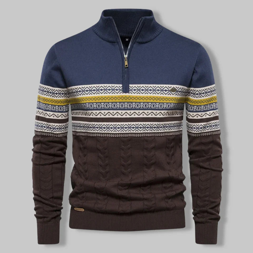Navy and brown sweater with patterned sleeves on a gray background