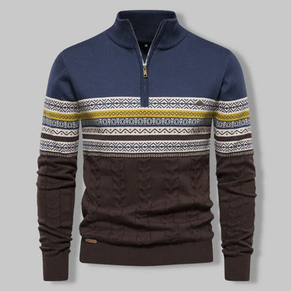 Navy and brown sweater with patterned sleeves on a gray background