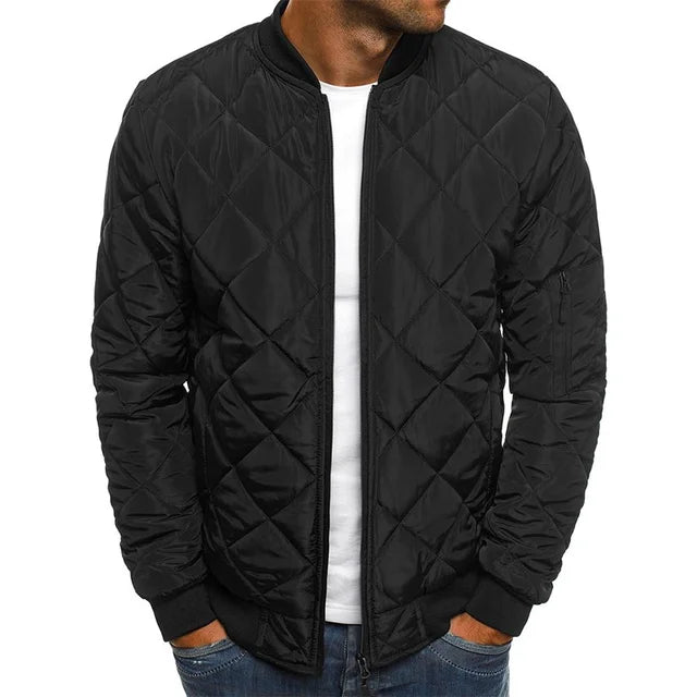 Black quilted jacket worn by a person on a white background