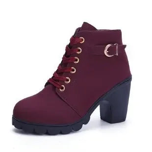 Maroon ankle boot with gold laces on a white background