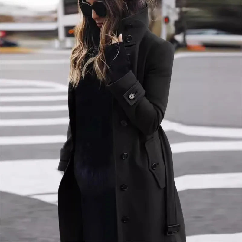 Person wearing a black coat on a city street