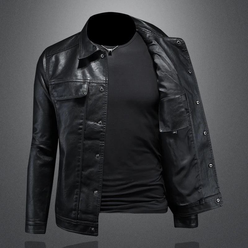 Black leather jacket over a black shirt on a gray background