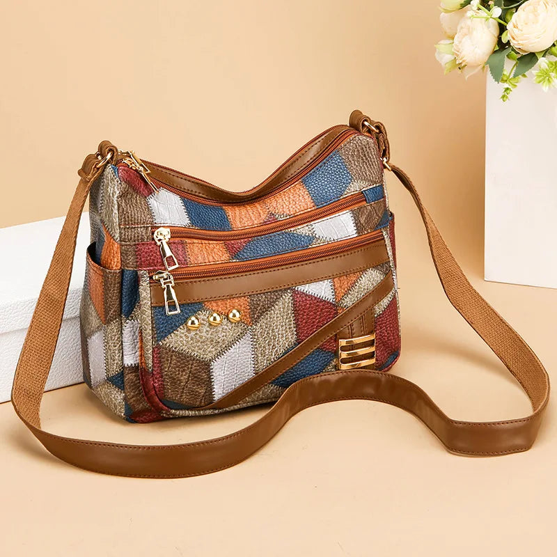 Multicolored patterned handbag with brown strap on a beige background