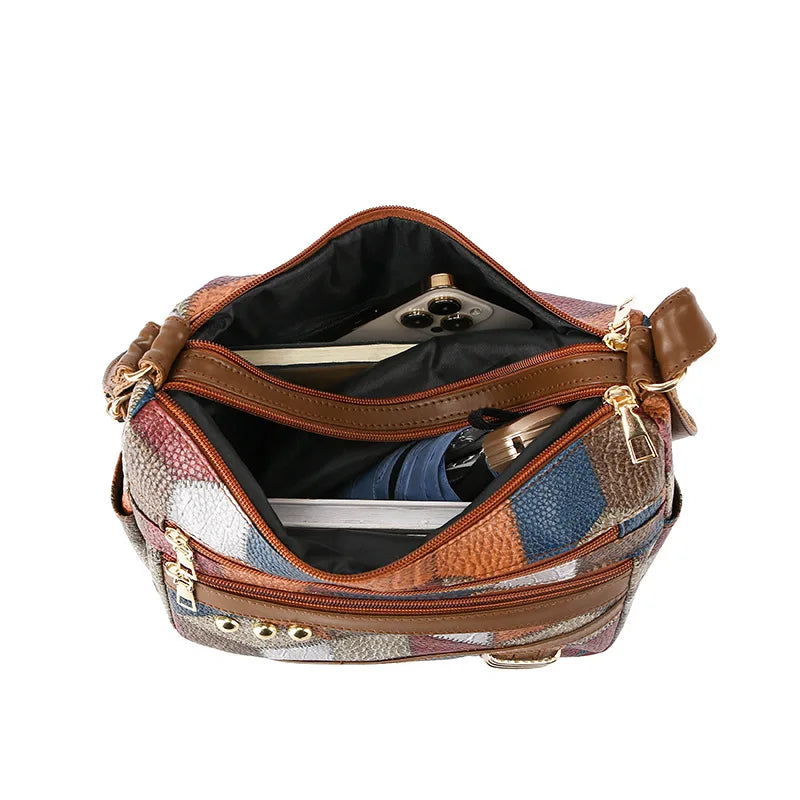 Multicolored patterned handbag with open front pocket on a white background