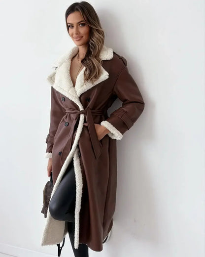 Woman wearing a brown coat with white fur lining against a white background
